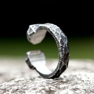 Angled view of Norse rune open ring on plain white background