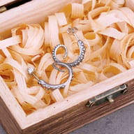 Side profile of the curved kraken tentacle stud earring with post backing