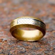 Close-up on the lower side of the ring, showcasing the intricate Celtic knot pattern and adjacent runes.