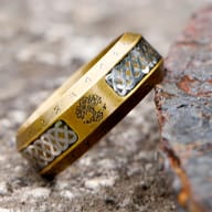 Side profile of the ancient-style stainless steel ring, revealing its distressed finish and runic inscriptions.