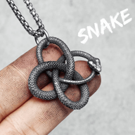 Full view of the Ouroboros pendant and chain against a neutral background