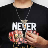 Gold 316L stainless steel cigarette holder pendant with an open cap and cigarette, beside a gold chain.
