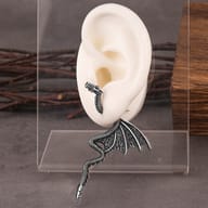 Overhead view of both dragon earrings highlighting the wing span and curved tail profile