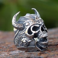 Detailed view of the right horn and Celtic cross symbol on the Viking skull ring's helmet