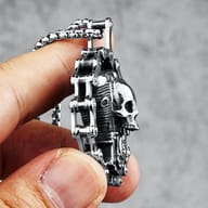 Frontal close-up of the skull and engine design within the motorcycle chain border, focusing on the textured surfaces.