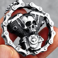 Side profile close-up of the skull engine biker pendant, emphasizing the detailed cylinder fins and mechanical elements.