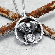 Detailed view of the skull engine pendant, framed by a motorcycle chain, with 'SKELETON POWER' text in the background.