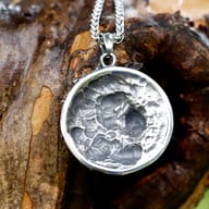 Viking lion head pendant worn as a necklace, demonstrating size and style