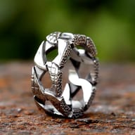 Vintage stainless steel ring featuring interconnected chain links, some polished and some with a granulated texture on their edges.