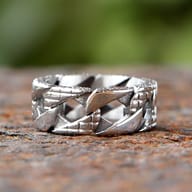 Macro shot revealing the intricate textured pattern on one segment of the ring