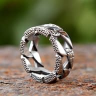 Side view of the robust chain link ring showing its full band width and texture