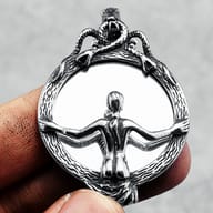 Detail view of the figure in the mirror and the surrounding serpent/root frame
