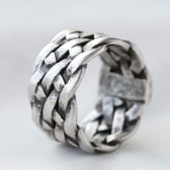 Macro shot of the antiqued finish and interlocked elements of the braided ring.