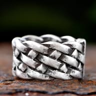 Close-up of the intricately braided texture of the gothic stainless steel ring.