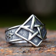 Angled close-up of the pentagram ring's textured band and star symbol.