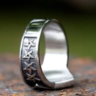 Side angle of the pentagram ring, highlighting the detailed band and additional star carving.