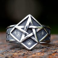 Top view of the Gothic pentagram ring showing detailed star design against a dark background.