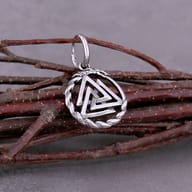 Side angle view of the 316L stainless steel huggie hoop and Valknut pendant