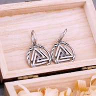Pair of Viking Valknut and Ouroboros drop earrings resting inside a wooden gift box