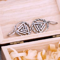 Pair of Nordic Valknut dangle earrings resting flat showing antique silver finish