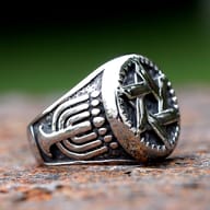 Angled close-up of the durable 316L stainless steel hexagram ring, showing band details.