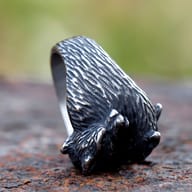 Another close-up of the curled fox ring, showing the rustic finish and details of its back.