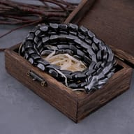 Men's Nordic Ouroboros statement chain necklace displayed on dark slate