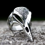 Front angle view of the raven beak and engraved Celtic knot steel ring