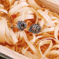 Back view of stainless steel lion stud earring showing post and backing