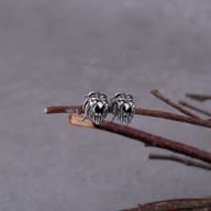 Close up front view of detailed 316L stainless steel lion head stud earring