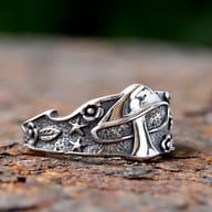 Gothic mushroom and forest motif ring crafted from durable 316L stainless steel, resting on a rustic surface.