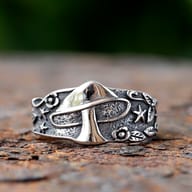 Section of the Gothic mushroom ring showing intricate star and leaf details against a dark, textured finish.