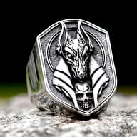 Close-up front view of the stainless steel Egyptian Anubis signet ring with skull accent