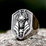 Macro detail of the sculpted Anubis jackal face and antique finish