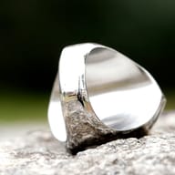 Egyptian Anubis stainless steel ring displayed on a stone surface