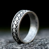 Men's 316L Stainless Steel Braided Viking Ring on a rough stone surface