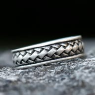 Side view of the 316L stainless steel braided ring showing its oxidized texture on stone