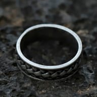Angled view highlighting the ancient-inspired braided design of the stainless steel ring