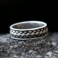 Detail of the smooth interior band of the 316L stainless steel ring against a dark background