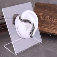 Close-up of the antiqued finish on the steel angel wing earring