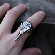 View of the raven's beak and the detailed patterns on the side of the Viking-inspired ring.