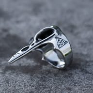 Intricate shot highlighting the elongated beak of the stainless steel raven head ring.