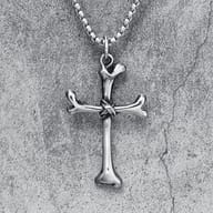 Close-up of the left horizontal arm of the 316L stainless steel bone cross pendant.