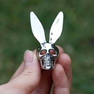 Close-up detail of the carved skull eye sockets and mirror-polished finish