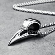 Detailed close-up of the crow skull pendant's beak and eye socket crafted from stainless steel.