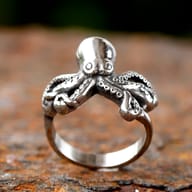 Angled view focusing on the textured tentacles and suction cups of the stainless steel octopus ring.