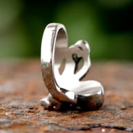 Detail of the octopus ring's body and eyes, highlighting the contrasting polished and oxidized finishes.