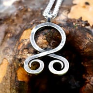 Viking troll cross pendant shown on model neck displaying size and drape