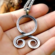 Angled perspective showing the thickness and antique steel finish of the Norse amulet