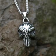 Close-up front view of steel Revenge skull pendant with chain